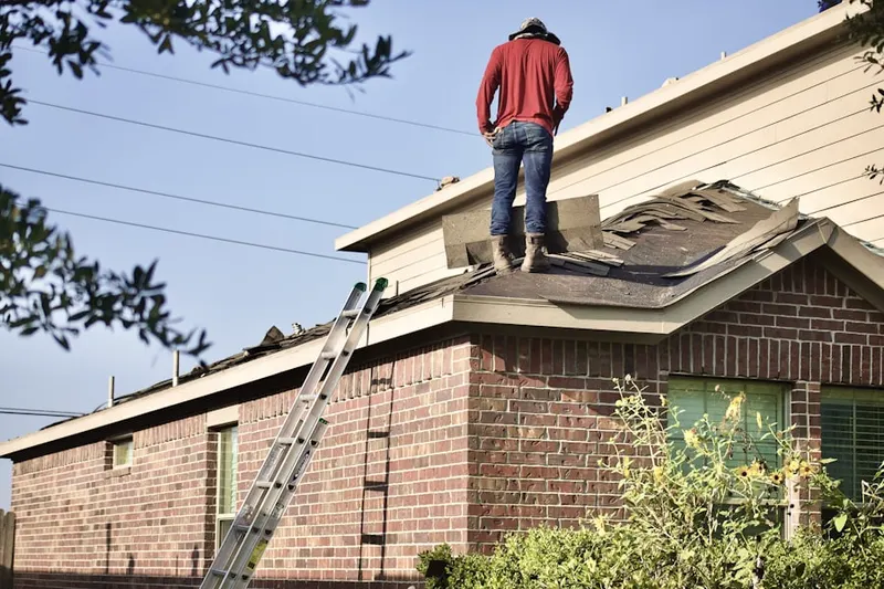 Professional roofer working on a residential roof in Monterrey Village